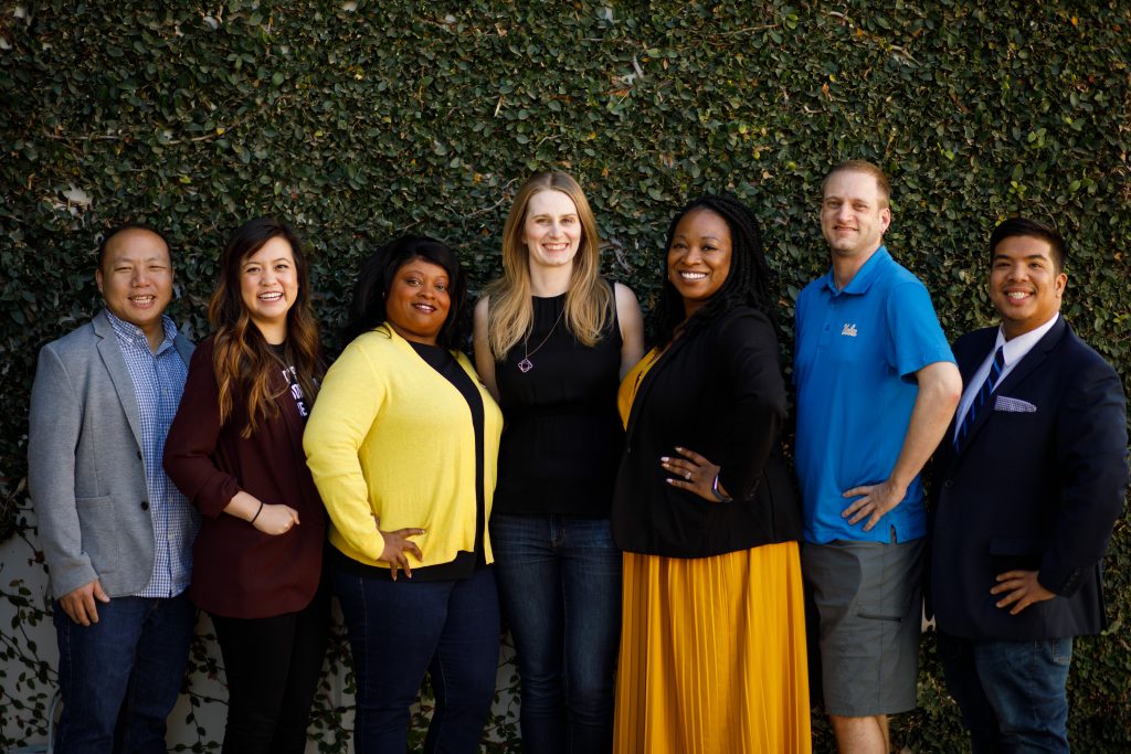 A group of California members smiling for a photo in a line