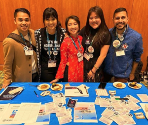 APAN entity leaders overseeing a marketing table at ACPA Convention