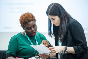 photo of two acpa members looking at a piece of paper