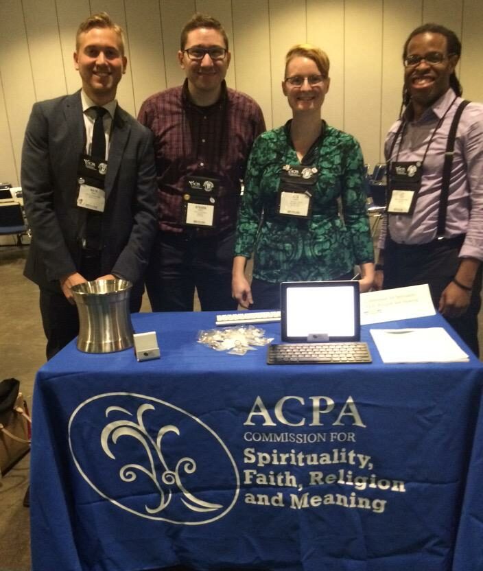 group photo of some CSFRM members smiling behind a table at Convention