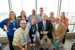 group photo of award recipients gathered around their award