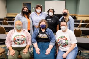 Photo of seven members of the CFI Directorate Board. 3 sitting on chairs with 4 standing in a row behind. All people are wearing KN95 masks.
