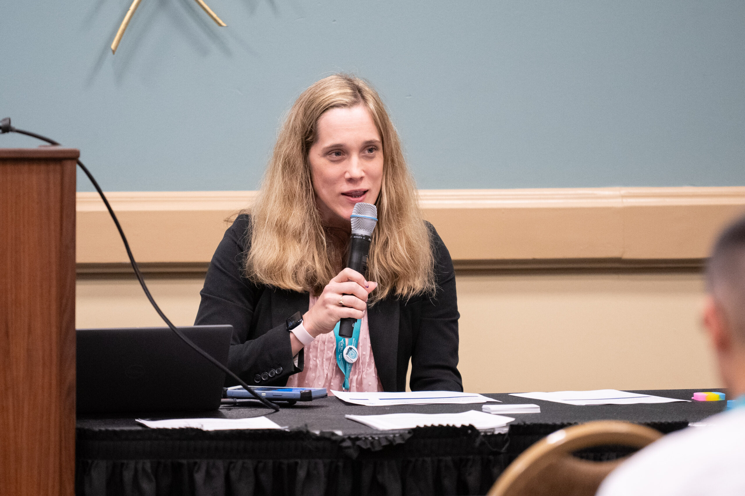 photo of ACPA member holding an ACPA award and smiling at the camera